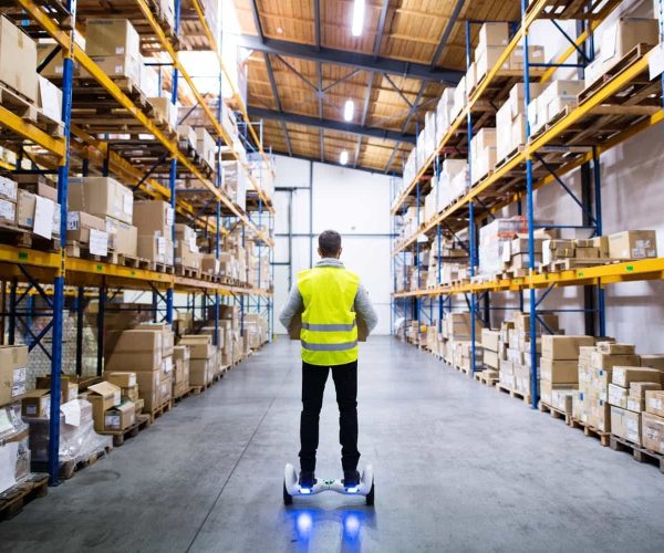 up-male-warehouse-worker-on-hoverboard-2021-08-26-12-07-53-utc-min.jpg up-male-warehouse-worker-on-hoverboard-2021-08-26-12-07-53-utc-min.jpg